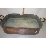 A large copper double handled rectangular pan