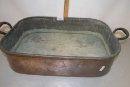 A large copper double handled rectangular pan