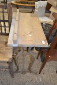 An iron framed and pine top side table, 71cm wide