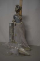 A large Lladro figurine of a lady with a parasol (a/f)
