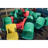 Large quantity of plastic revolving desk chairs and others