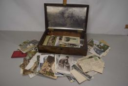 A hardwood case containing various mixed postcards