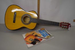 Acoustic guitar and accompanying Learn to Play book