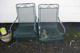 A pair of green mesh metal garden chairs