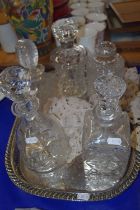 Silver plated serving tray containing various assorted decanters