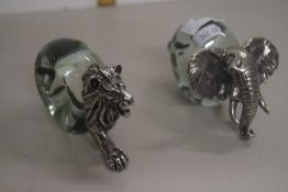 A pair of novelty napkin rings formed as a lion and an elephant