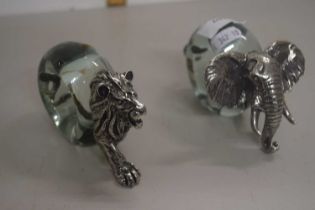 A pair of novelty napkin rings formed as a lion and an elephant