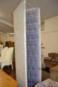 A three tier fabric upholstered folding screen