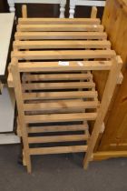 A pine slatted three tier shelf rack