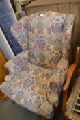 A floral upholstered wing back armchair