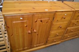 A pine sideboard of two cupboards and four drawers