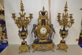 20th Century French clock garniture with central clock with cherub decoration together with a pair