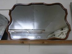 Early 20th Century bevelled wall mirror in a walnut frame