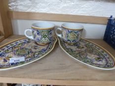 A pair of Portuguese cups and matching side plates
