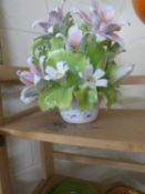 A pottery model of a vase of lilies and other flowers