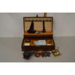 A jewellery box containing various costume jewellery and other items