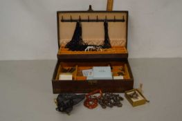 A jewellery box containing various costume jewellery and other items