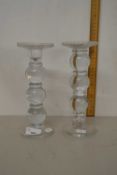 A pair of moulded clear glass candlesticks