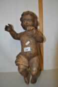 A contemporary carved figure of a child with chain hanging suspension
