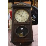 An early 20th Century oak cased wall clock of large porportions, 80cm high