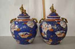 A pair of large 20th Century Oriental covered jars