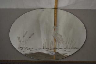 A circular wall mirror with heron decoration