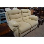 An oatmeal two seater recliner sofa