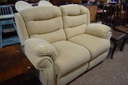 An oatmeal two seater recliner sofa