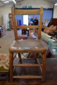 A Victorian elm seated child's chair together with tapestry covered footstool
