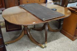A mahogany twin pedestal dining table with extension leaf