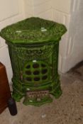 A decorative continental green enamel finish stove with pierced floral decoration