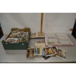 A large box of various assorted postcards