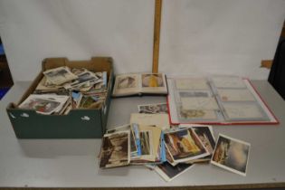 A large box of various assorted postcards