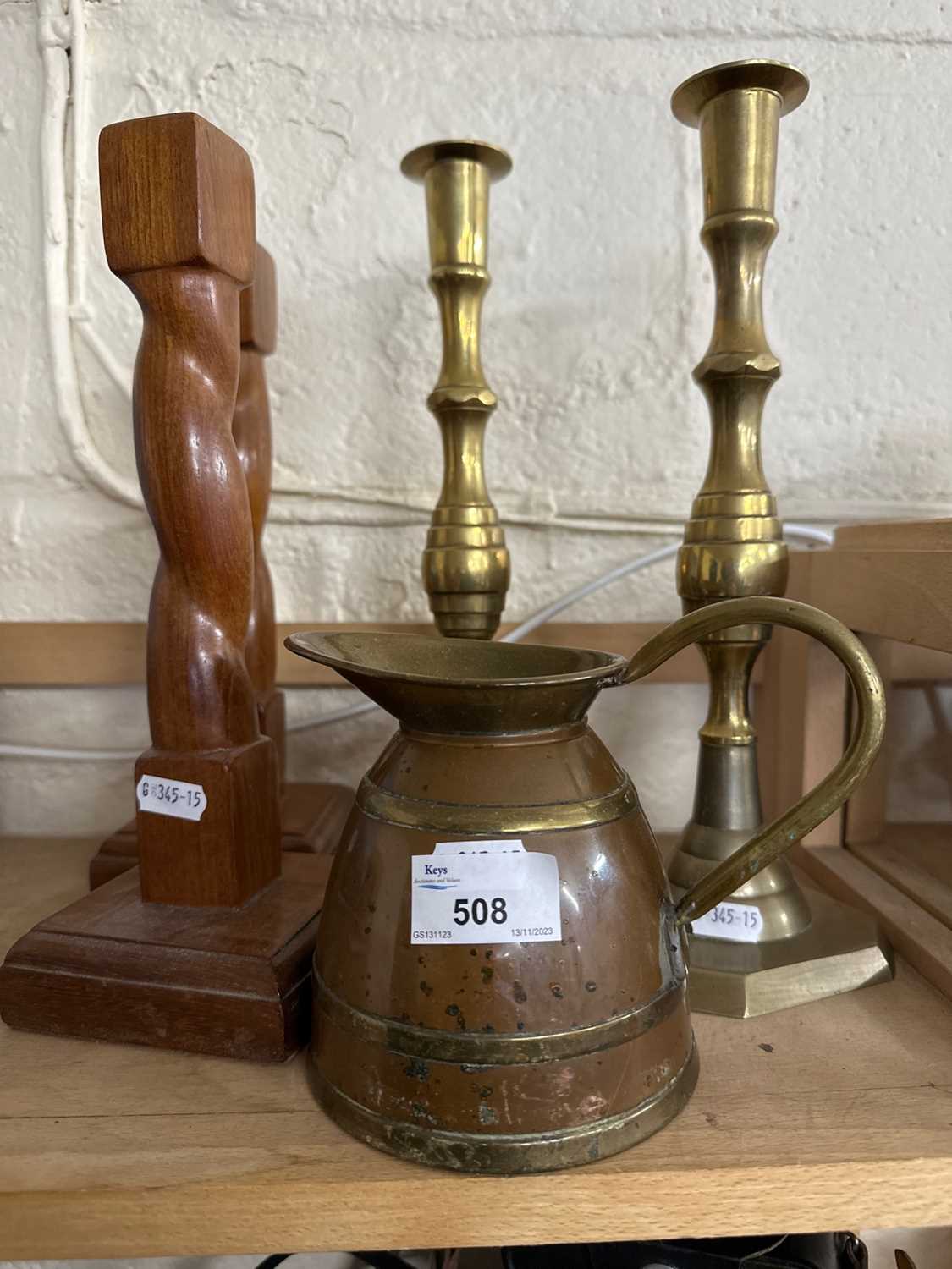 Pair of brass candlesticks, pair of wooden candlesticks and a coppered ewer