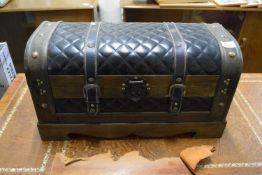A faux leather dome top trunk
