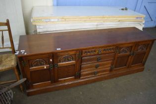 Dresser base with central drawers and cupboards to either side, approx 183cm wide