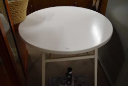A white folding round table