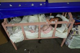 Pink cot and a doll