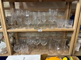 Two shelves of assorted glass ware to include wine glasses, tumblers, brandy balloons etc