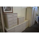 A six piece bedroom suite comprising two wardrobes, pair of bedside cabinets, chest of drawers and a