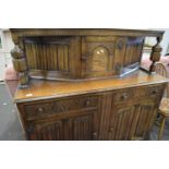 A reproduction oak linen fold front court cupboard