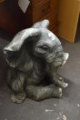 A plastic model of a seated elephant