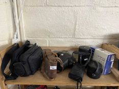 A quantity of assorted cameras, lenses and cases