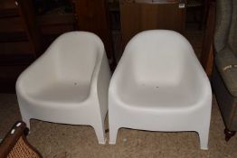 A pair of Ikea Skarpo white plastic garden chairs