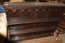 A oak plate rack initialled EM and dated 1779