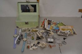 A box containing various assorted wristwatches, postcards and vintage photographs
