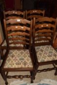 A set of four modern oak dining chairs by H J Berry