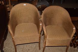 A pair of gold finish Lloyd Loom chairs plus a further ottoman