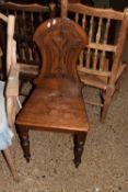 A Victorian hall chair with floral carved back