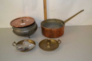 A circular pewter bowl and a copper saucepan and two brass chamber sticks
